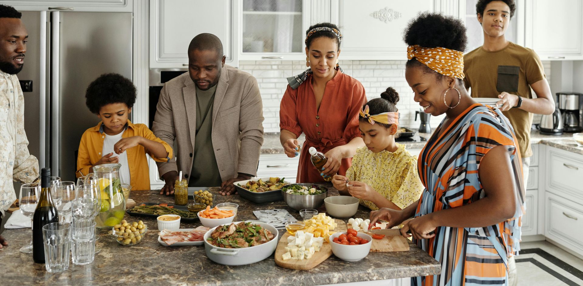 A happy family gathers in the kitchen to prepare a delicious meal together, fostering togetherness and joy.